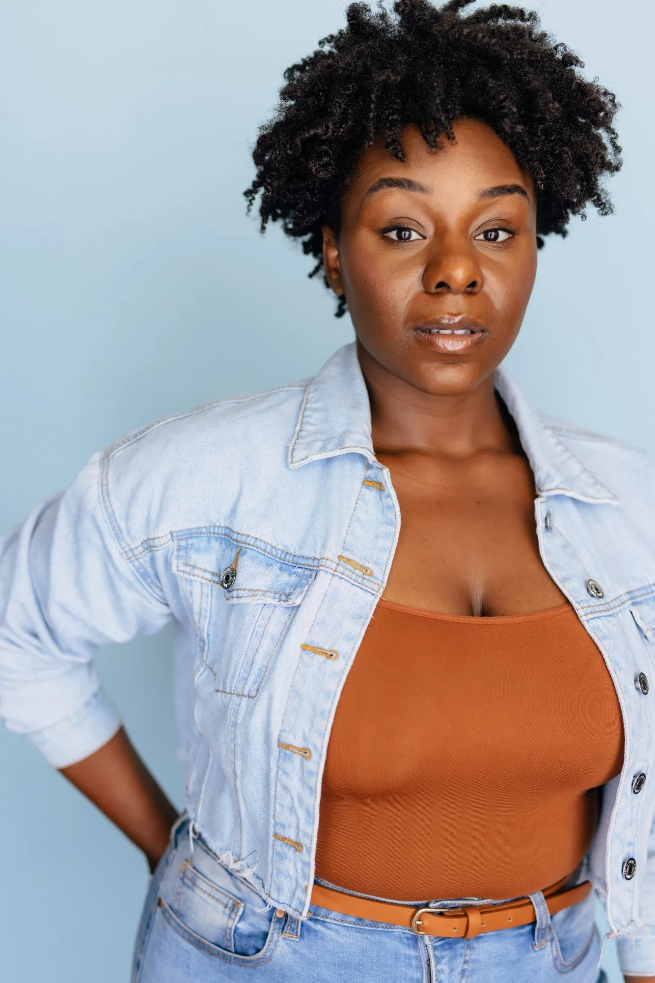 Abigail in a denim shirt against a light blue background