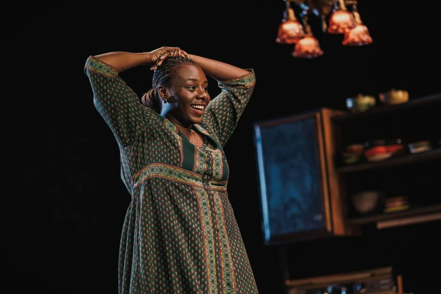 Abigail in a green patterned dress in Sojourners